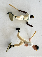 Two Starting Lineup baseball figures shown from above. Figures in Athletics uniform holding bats in swinging poses.