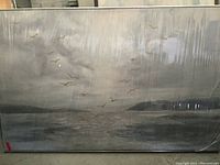 Full view of the large framed abstract painting covered in protective plastic showing reflective surface, seabird motif in muted gray, brown and white tones.