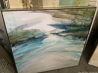 Framed abstract print showing blue, green, and white watery abstract design