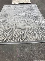 Top and angled view of the large synthetic area rug showing full pattern and size comparison.