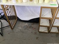 Front view of entire desk showing glass top, frame and shelves