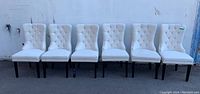 Front view of all six chairs in a row against white background
