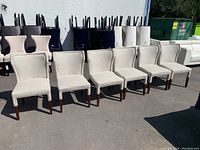 Six chairs lined up outdoors showing front and side profiles
