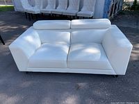 Front view showing overall shape, cushions, arms and headrests