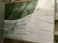 Full view of the framed abstract painting showing green and white colors with textured strokes.