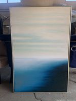 Full view of the framed canvas print showing the abstract blue gradient design.