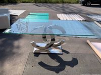 Front perspective view of dining table showing full glass top and chrome base