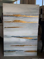 Full view of textured abstract print with horizontal gold foil accents on a gray and white background.