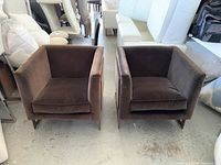 Front view of both chairs side by side showing seat cushions and armrests.