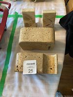 All four pieces of the lot - two stone animal bookends and two rectangular marble pillars, placed on a table.