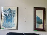 Two framed artworks hanging above couch: left abstract geometric and leaf design, right vertical mountain river landscape