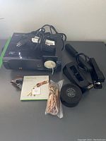 ViewSonic projector, power adapters, stapler, tape dispenser, Tile Mate box and office accessories shown from above on a flat surface.