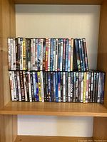 Two shelves of assorted DVDs, titles include Dirty Harry, Dreamgirls, Despicable Me, others.
