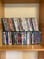 Two shelves filled with DVD movies including classic and popular titles.