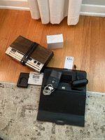 Overview of vintage clock radio, temperature monitor, iPod, black digital clock, and speaker dock.