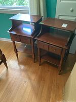 Two Vilas matching wooden night stands side by side on a hardwood floor, showing overall condition and design.