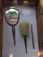 Full view of Birks sterling dresser set: mirror, brush, comb handle on a white paper towel background in a box