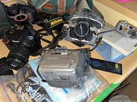 Overview of all cameras, cases, bags and accessories on countertop