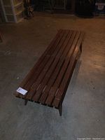 Front view of wooden slat coffee table showing the surface slats and overall length.