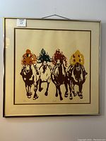 Framed screen print showing four stylized racehorses with jockeys in colored silks.