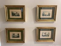 Four vintage framed prints hung on a wall, arranged in a square pattern, showing their general size and presentation style.