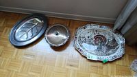 Wide view of all three platters on floor showing size and designs