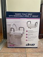 Front side of box showing product name, image, and convenience, comfort, tool-free installation, and weight capacity features.