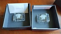 Two Rosenthal Versace crystal napkin rings in original black boxes with paperwork.
