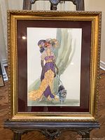 Full view of framed fashion print featuring woman in elegant dress and dog.