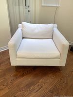 Front view showing seat cushion, back cushion, arms and legs