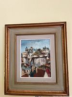 Full view of the framed painting showing overall composition, frame and mat.