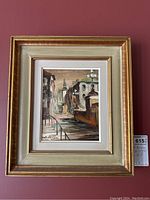 Full view of framed oil painting on red background