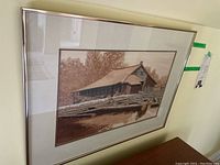Full view of framed watercolour painting showing sawmill scene