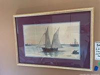 Full view of framed watercolor painting depicting sailboat and distant vessels