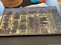 Front view showing full rectangular relief tile composition in iron frame