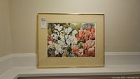 Framed and matted watercolour painting by Mary Cromarty titled 'Cyclamines Galore,' showing floral cyclamen design in multiple colors, hung against a beige wall.