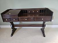 Front view of desk showing overall form, pedestal base and drawer arrangement