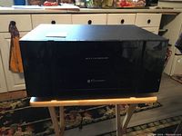 Front view of Cayan Media HD 11 receiver showing model name and clean black front panel.