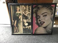 Overview photo showing both Marilyn Monroe framed picture prints on carpeted floor, including the close-up portrait with pink background and the multi-photo collage.