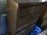 Side and partial front view of pine dresser showing wood grain and surface condition.