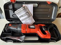 Black & Decker reciprocating saw in carrying case with instruction manual visible