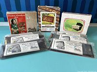 Image showing multiple vintage Tandy leather kits including handbag and billfold kits, all in packaging and sealed or unopened.