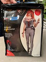 Front of packaging showing the costume worn on model, branding, and details