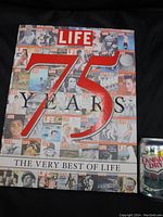 Photo of the book cover showing a collage of classic LIFE magazine covers with a large 75 Years text and LIFE masthead, accompanied by a can of Canada Dry for size reference.
