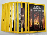Twelve National Geographic magazines arranged side by side, showing the yellow border covers and various cover images under good condition.