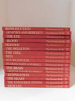 Stack of 16 hardcover books showing titles and spine design