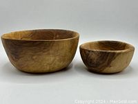 Front and side view of large and small wood bowl, showing natural wood grain color variations and smooth finish.