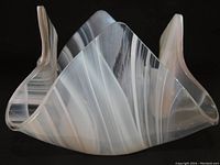 Art glass bowl with clear, white, and pale lavender/pink ribbons, showing the handkerchief swirl shape with folded edges against a black background.