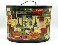 Front view of the Paris label collage design carrying case showing curved edges, handle and metal clasp.