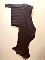 Irregularly shaped dark brown leather hide laid flat on a light-colored surface showing the full size and shape.
